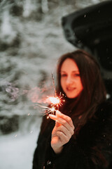 Portrait of a woman with sparklers in her hands