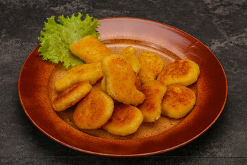 Fried chicken nuggets served salad leaves