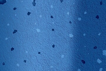 Blue surface texture with light and dark spots. Blue background