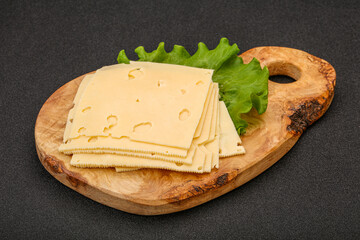 Sliced yellow cheese over board