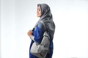 portrait of an Asian woman wearing work or school clothes. hooded women carry a casual backpack. learning or working photo concepts with happy expressions