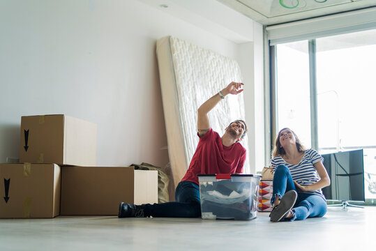 Young couple relaxing in their new home