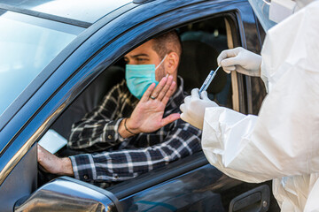 Man refuses medical worker in PPE trying to performing drive-thru COVID-19 test