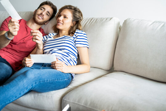 Young couple talking with each other on sofa in their new house