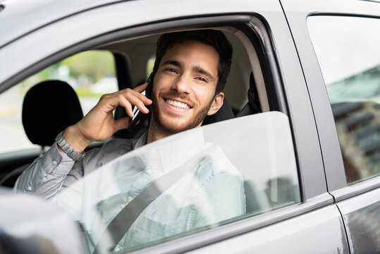 Young man sitting in car