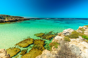 Tourism in Perth. Rottnest Island, Western Australia. Scenic view from roks over tropical reef in turquoise crystal clear sea of Little Salmon Bay, a paradise for snorkeling, swimming and sunbathing.