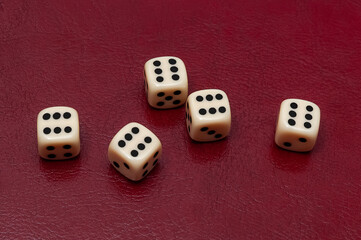 White dice for games on red background