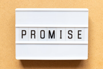 Lightbox with word promise on wood background