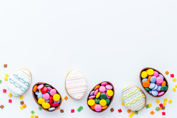 Happy Easter with chocolate eggs and sweets, top view