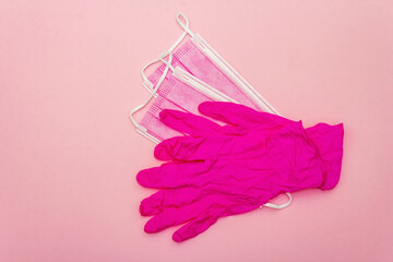 Fashion masks and glamour gloves isolated on pink background