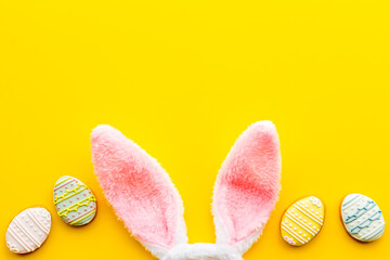 Happy Easter. Bunny ears with colorful eggs cookie, top view