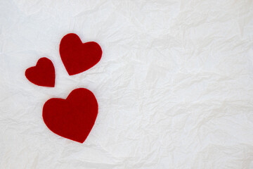 Red decorative heart on white paper background.