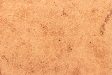 Old worn brown cardboard covered with stains.