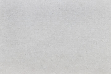 The texture of rough craft paper, interspersed with fibers and particles...
