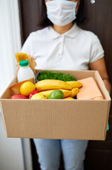 Courier with packing box with food, contactless delivery