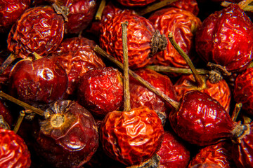 Dried herbs Red rosehip with tails. High concentration of vitamin C, pharmaceutical herb, vitamin tea. macro shooting