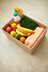 Donation box with food on the floor at home, coronavirus outbreak