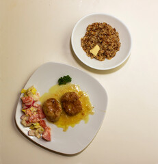 pork cutlets with buckwheat porridge garnish on a white background