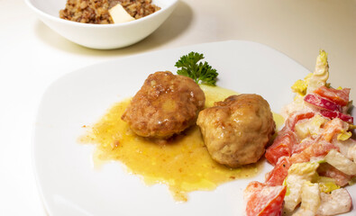 pork cutlets with buckwheat porridge garnish on a white background