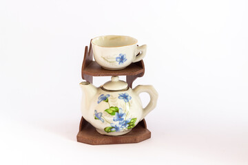 Ceramic mini tea set isolated on white background. Miniature blue and white ceramic tea set.