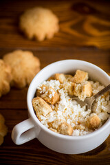 Homemade cottage cheese with pieces of shortbread cookies for breakfast
