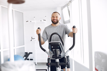 A man is doing the exercises. He has a training. The patient uses a spin bike.