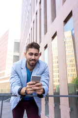 Portrait of Handsome young man smiling when he is using his mobile phone