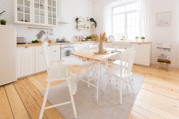 cute cozy light interior design of the apartment with a free layout of the kitchen and bedroom areas. a lot of windows, a wooden floor and a hanging swing.