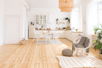 cute cozy light interior design of the apartment with a free layout of the kitchen and bedroom areas. a lot of windows, a wooden floor and a hanging swing.