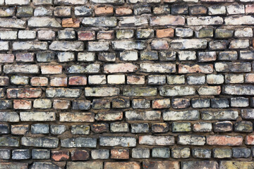 Grunge red dirty brick wall. Urban underground texture. Antique house exterior wall. Vintage rustic building architecture.