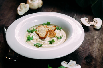 Mushroom cream soup on a white plate