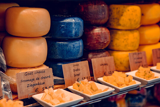 Gouda, Netherlands - July 20, 2020: many different kinds large delicious hunks of cheese on the shelves on sale in a Cheese shop in Gouda