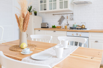 cute cozy light interior design of the apartment with a free layout of the kitchen and bedroom areas. a lot of windows, a wooden floor and a hanging swing.