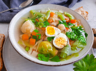 vegetable soup, quail egg on a concrete background