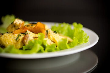 fried omelet with forest mushrooms chanterelles, on black background