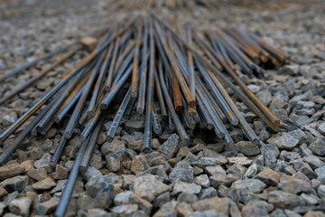 nfocused pile of rusty iron bars lying on rubble