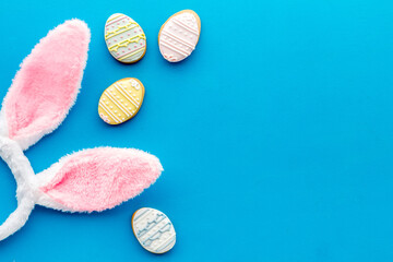 Happy Easter. Bunny ears with colorful eggs cookie, top view