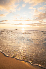 Wonderful golden sunset on the beach and calm sea.