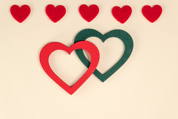 Hearts on pastel peach colors. Red and green hearts. Valentine's Day background. Valentine's Day concept. Flat lay.