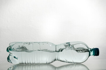 Plastic bottle of fresh clean water and waves of it