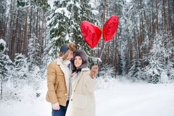 Winter couple in love. A boy and a girl embrace in the winter Snow and fairy forest. valentine's day