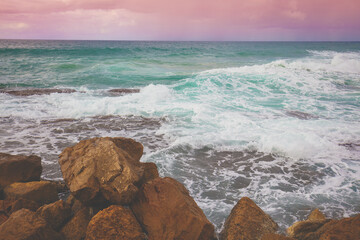 Rocky beach with big brown stones in evening. Nature of Israel