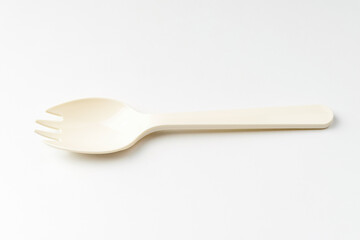 Plastic spork on white background