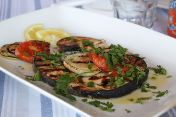 Grilled Swordfish on Cypriot Taverna Table with parsley, tomato and lemon