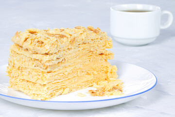 Napoleon Cake on a white plate. Traditional French dessert. Cake Napaleon of puff pastry on white background
