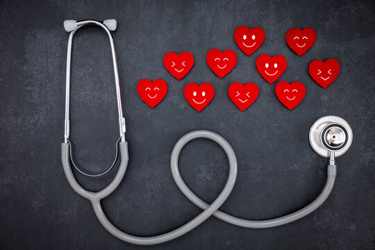 stethoscope and red hearts with emoticon faces