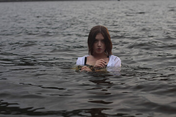 Young girl in the black water