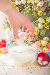 Festive Easter hot chocolate bomb. White chocolate bomb for hot cocoa drink, with marshmallow and sugar sprinkles