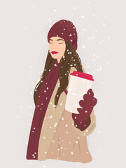 Portrait of a beautiful young lady wearing warm winter outfit, holding a paper cup of coffee, enjoying snowy weather