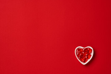 Valentines day concept or postcard. Small heart-shaped plate with small hearts inside. Holiday symbol. Space for text. Top view.